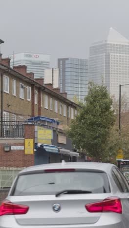 Vertical-Video-Showing-Contrast-Between-Poor-Inner-City-Housing-Development-And-Offices-Of-Wealthy-Financial-Institutions-London-Docklands-UK-4